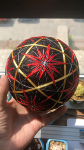 雪清瑶作品：新绣冰花手鞠球，黑底红花的直径约12厘米，白底蓝