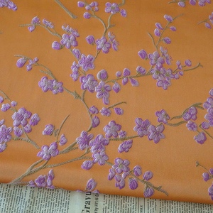 秋冬橙底紫花浮雕连衣裙提花面料时尚女装色织绝美窗帘质感布料