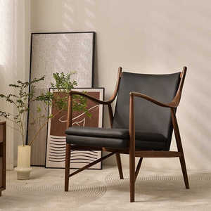 北欧实木软包靠背椅设计师款家用真皮椅子黑胡桃木单人极简沙发椅