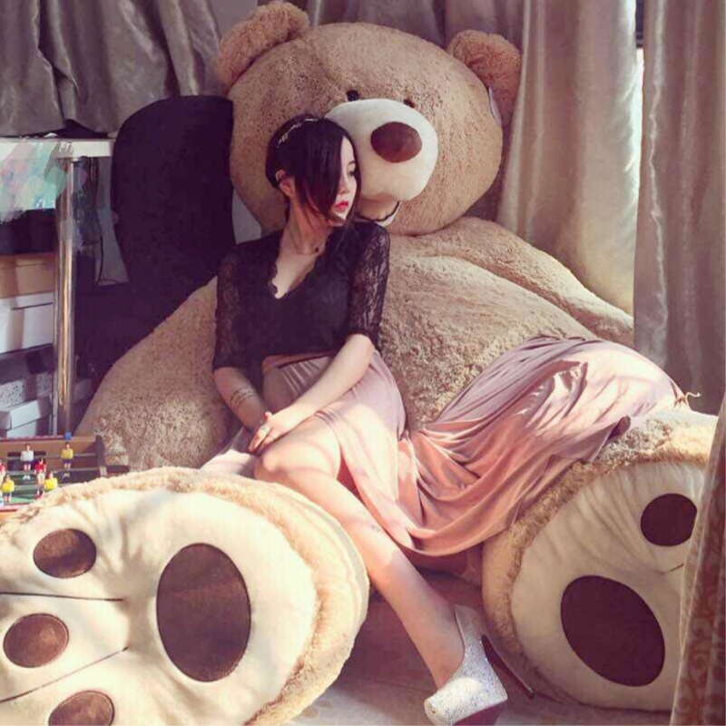 girl cuddling with giant teddy bear