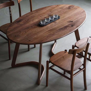 北欧黑胡桃木餐桌简约现代樱桃木椭圆形餐桌中式东方手工家具定制