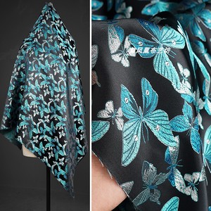 黑底湖蓝色蝴蝶飞舞织锦缎提花面料 丝滑有光泽中式外套服装布料