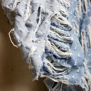 蓝白色水洗破洞破烂面料再造肌理创意牛仔布料镂空透视提花流苏