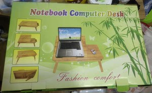 可收起床上电脑桌，竹子材料，全新，因放置，外包装褪色。北京丰