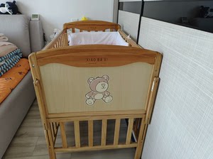 出实木婴儿床，品牌：笑巴喜，颜色为实木本色，款式为分床式，适