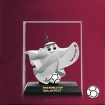 The official edition 2022 Qatar World Football Cup mascot hands the La eeb Rayib souvenir