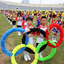 Five-ring props holding the School Games opening ceremony entrance phalanx team creative hand holding wreath props