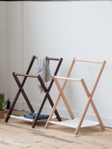 Sleeping in the bedroom at night putting clothes on the side of the bed landing real wood and temporarily taking off the clothes and hats.