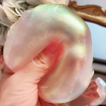 The Moonlight gem shines with neon colored pearlescent foam glue getting bigger and bigger slime