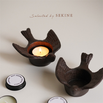 The small swallow retro cast iron candlestick in front of the window Japanese style round and simple and cute