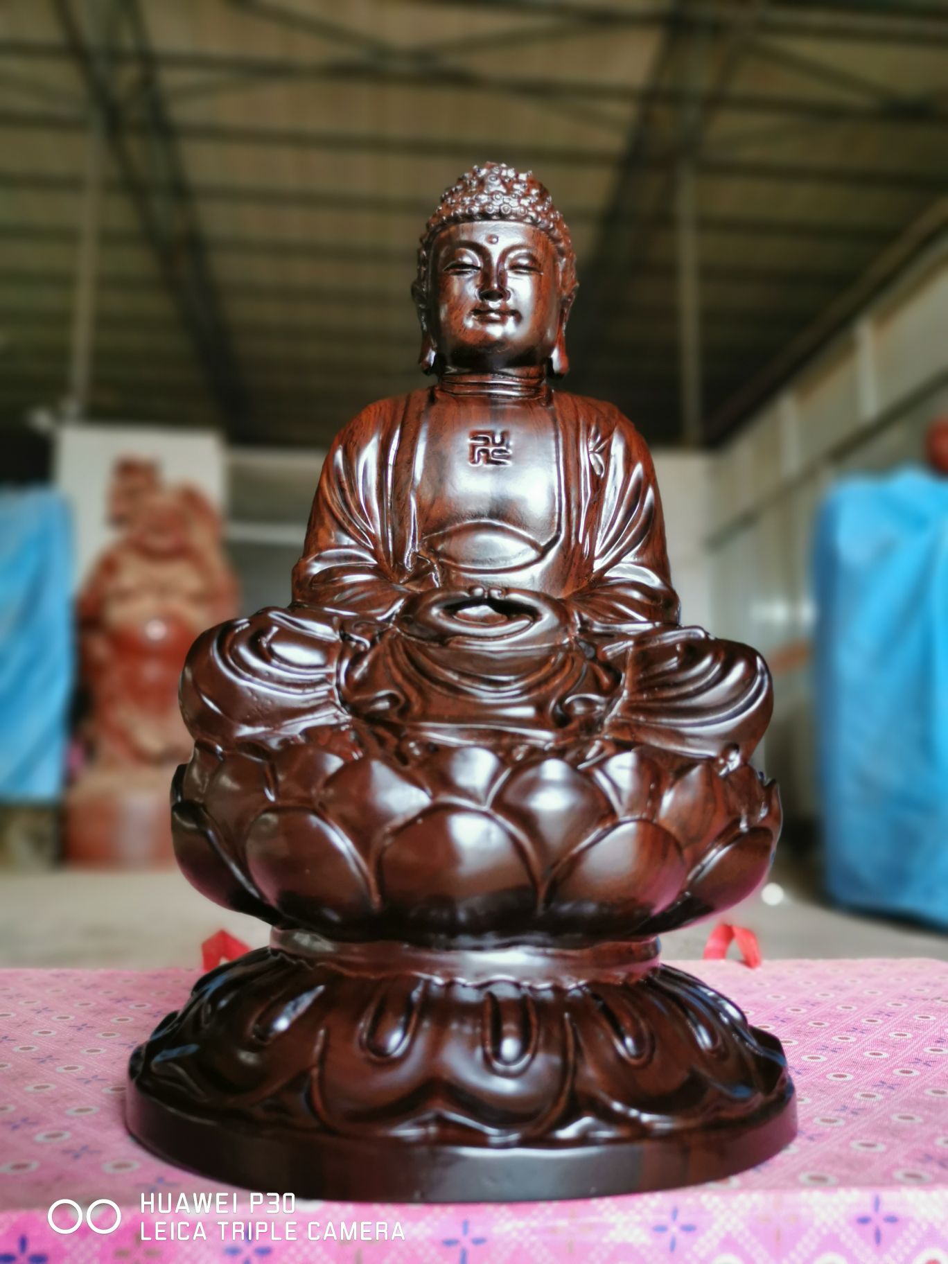 Ebony wood carvings of the Buddhas Sagamoni Buddha statue pose as a redwood home town house such as the Buddha statue to serve