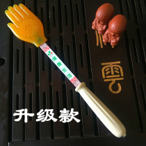 Palm clapping board health care massager knocks on the shoulder and back knocks on the back of the hammer with a small yellow hand slapping a silicone Meridian Pat