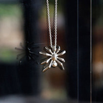 The artist originally designed the silver spider necklace