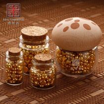 A bottle of golden beans a glass bottle of golden beans a small bottle of small golden beans a wishing bottle an exquisite empty bottle and a small and exquisite